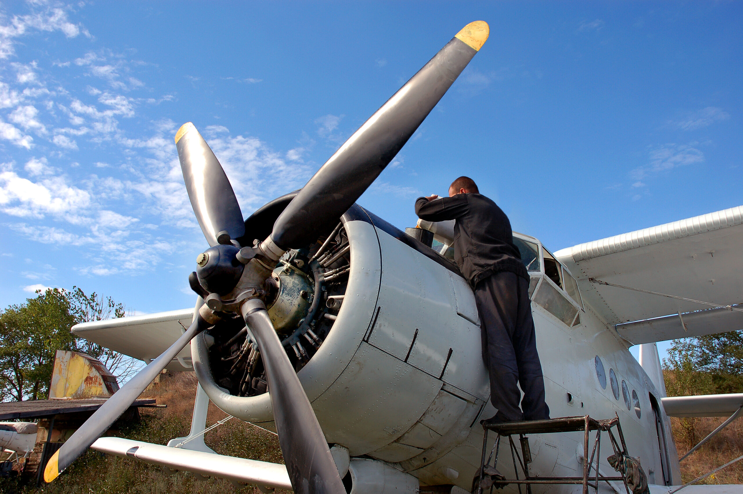 An aircraft mechanic prepares the plane for flight. First postwar Ukrainian plane AN-2.